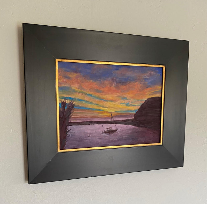 Framed image of a giclee print of an original oil painting of a sunset over Dana Point Harbor by Steve Sandborg Art
